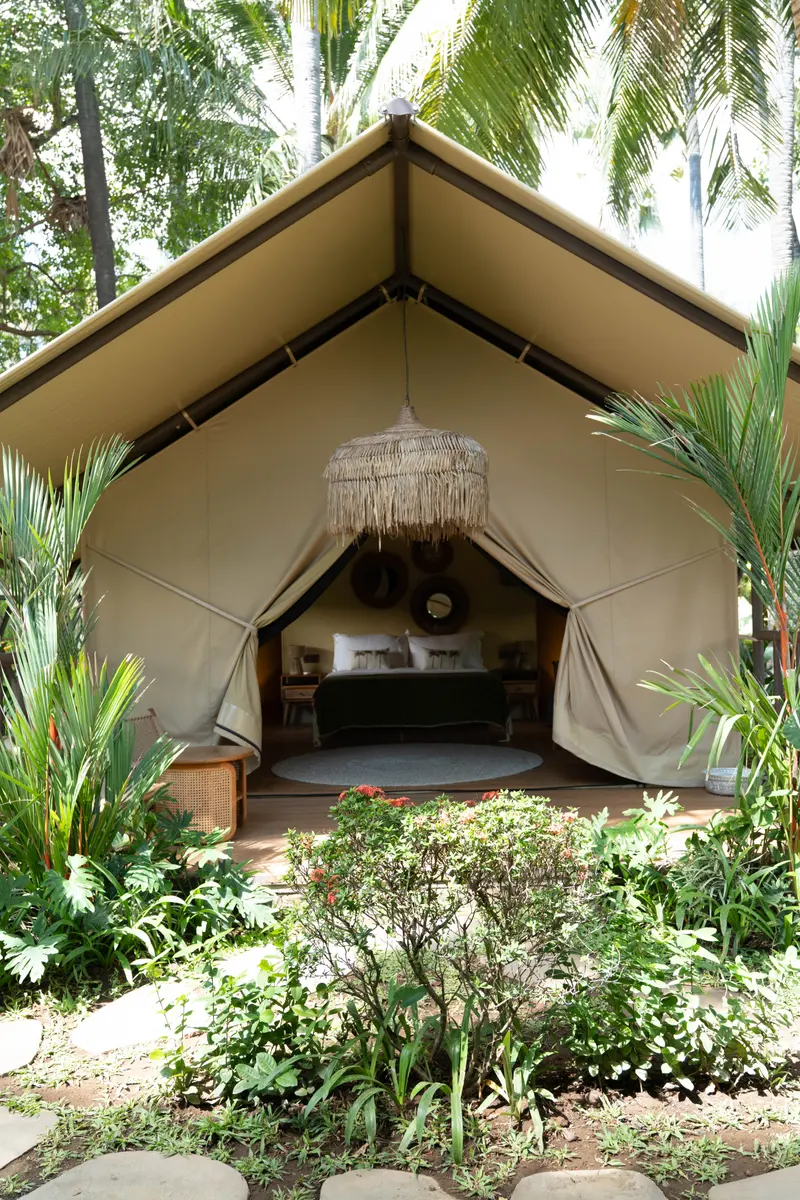 A canvas lodge, open to the garden.