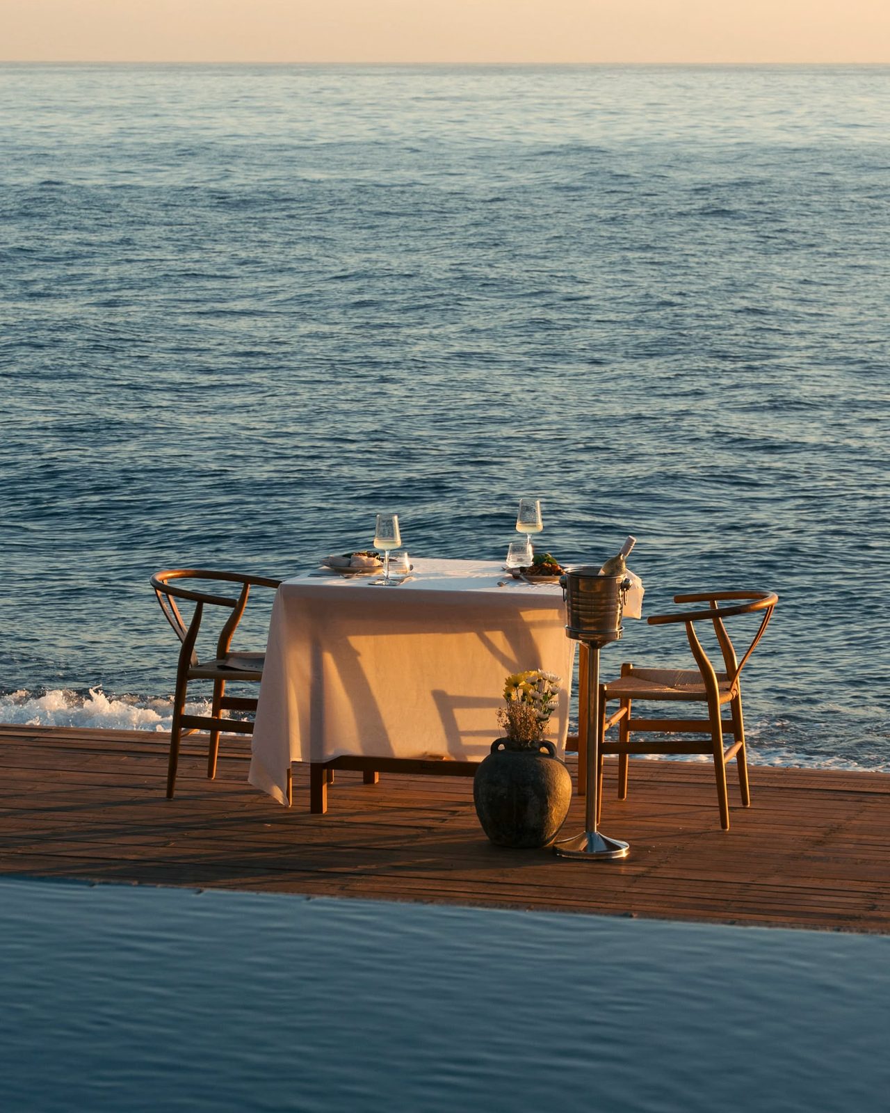 Dining on the deck at Saga as dusk settles over the coast