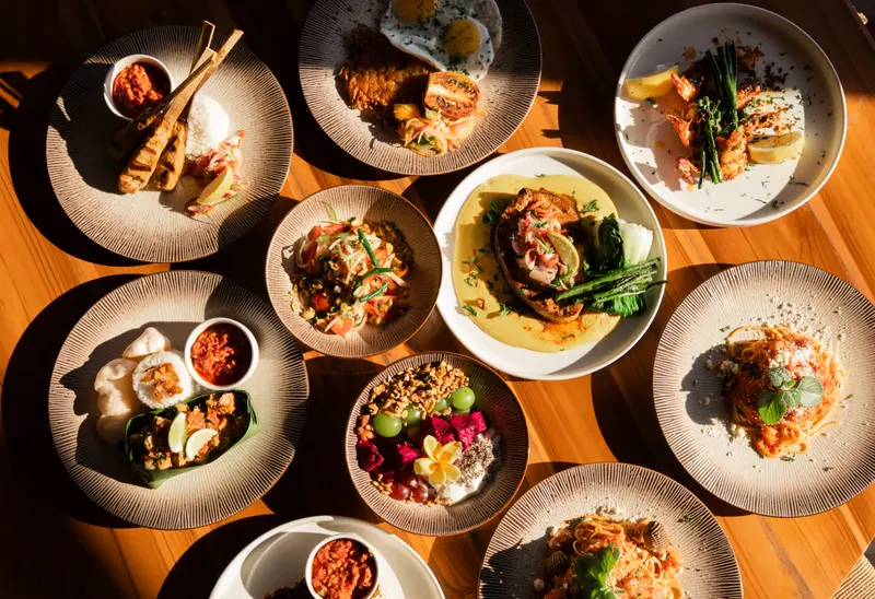 A shared table of coastal dishes at Saga, seen from above