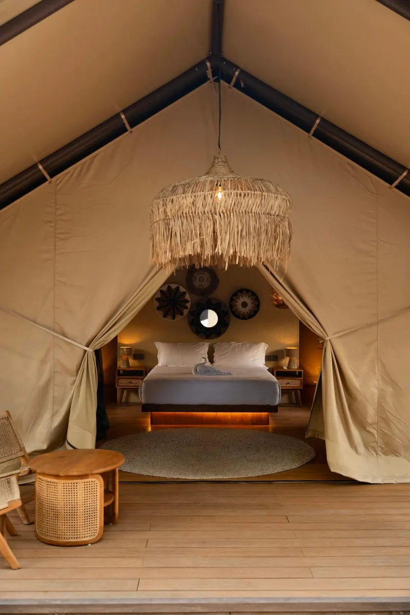 Bayu from the deck: the canvas peak, the fringed lamp and the bed inside
