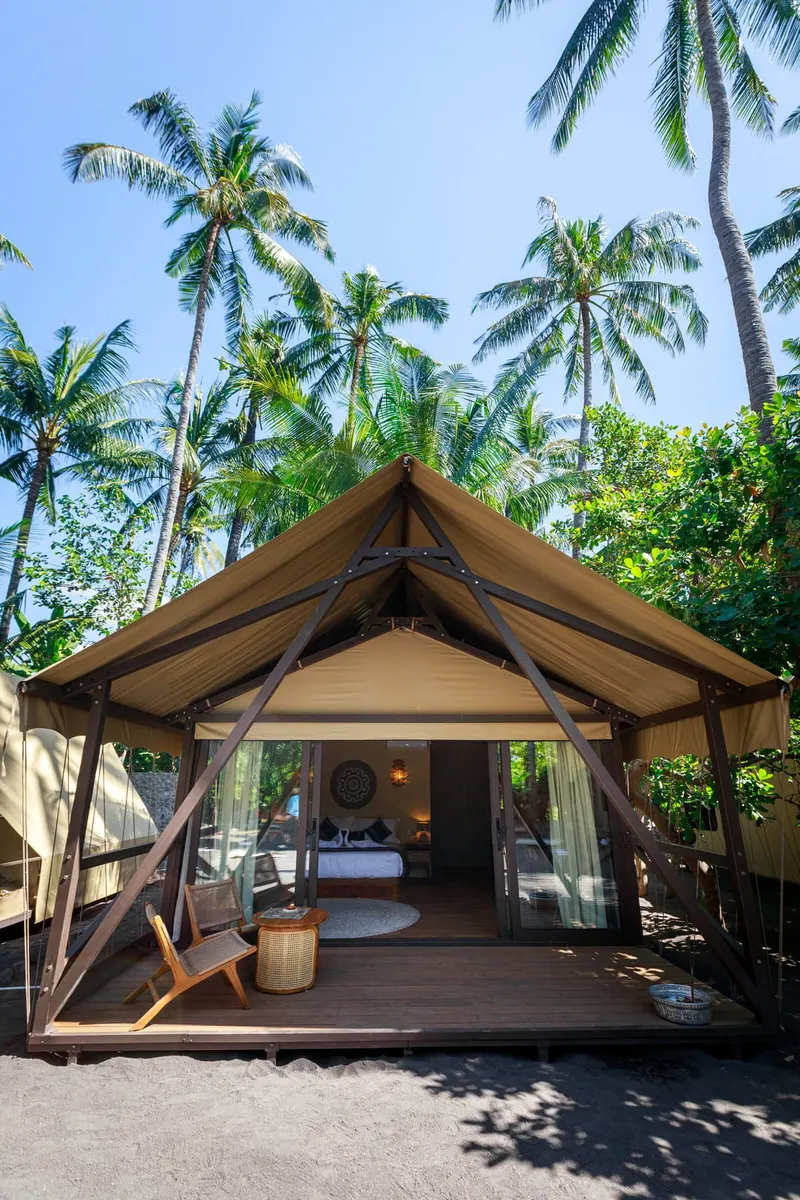 Segara under the coconut palms: the deck, the open front and the bed inside